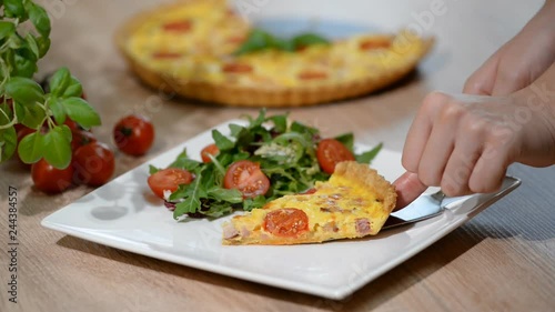 A piece of French quiche Lorraine. Quiche Lorraine with salad