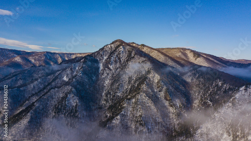 Aerial mountain fog covered the famous rock Lagonaki in morning light.