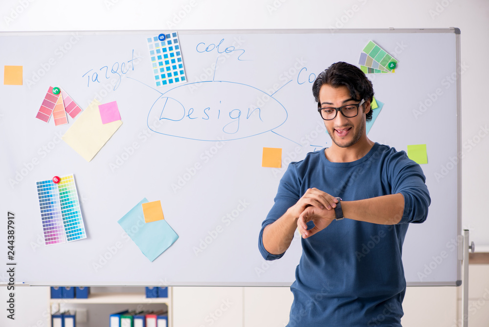 Young handsome designer working at the project Young handsome designer working at the project