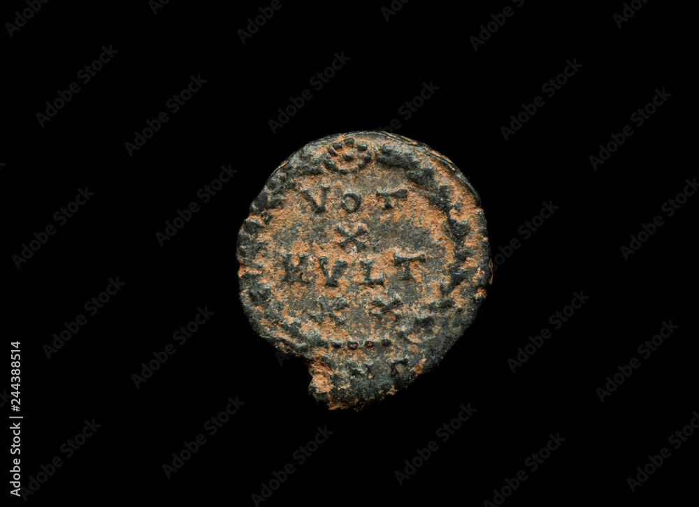 Ancient copper or bronze coin isolated on black, closeup Ancient copper or bronze coin isolated on black, closeup