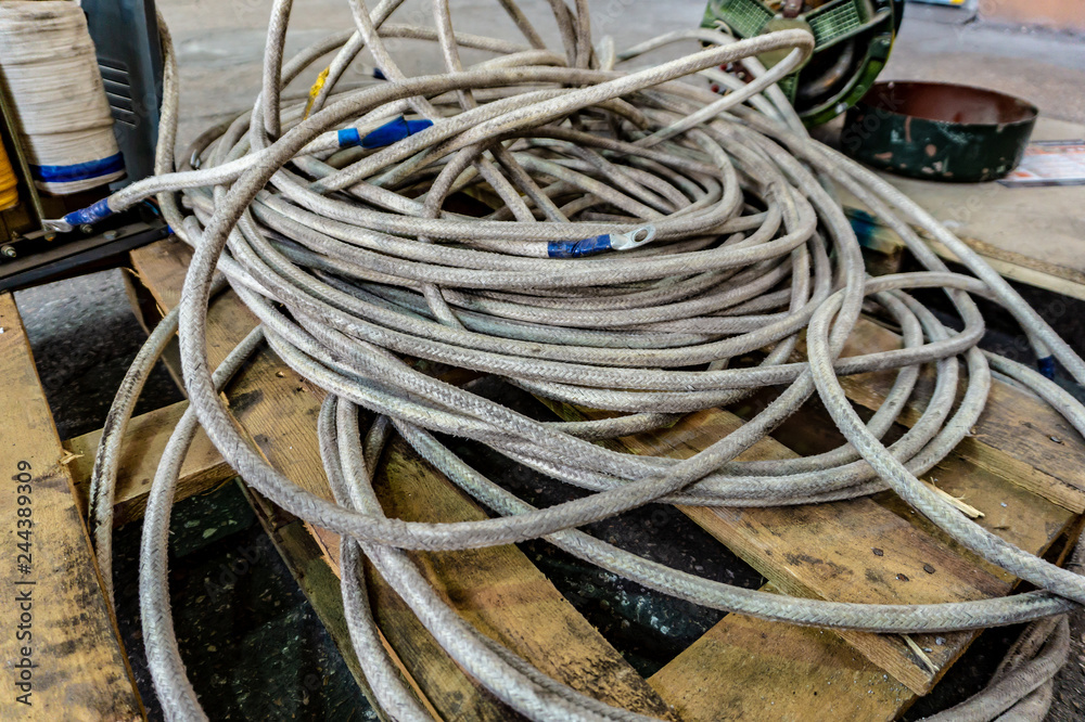 Thick powerful white cable and old transformer welding machine with copper  winding Photos | Adobe Stock