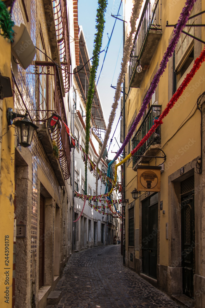 Lisbon, Portugal, June 16, 2018: Old narrow streets in Lisbon with different decorations