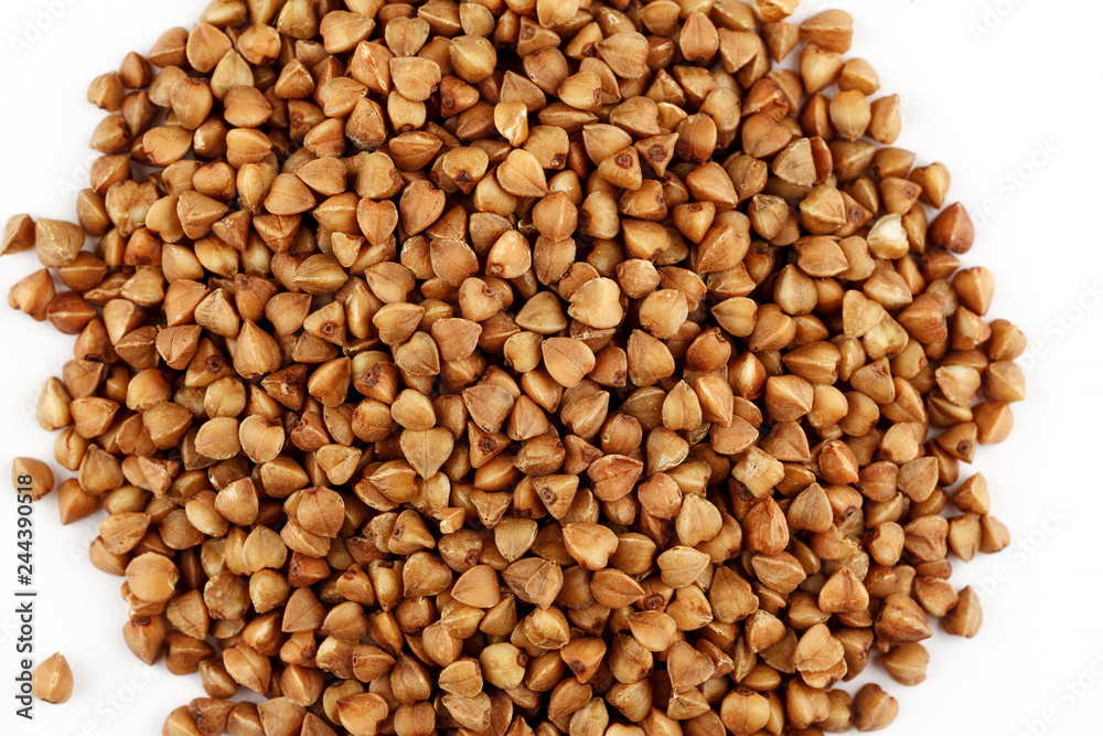 Pile of raw buckwheat seeds on a white background Pile of raw buckwheat seeds on a white background