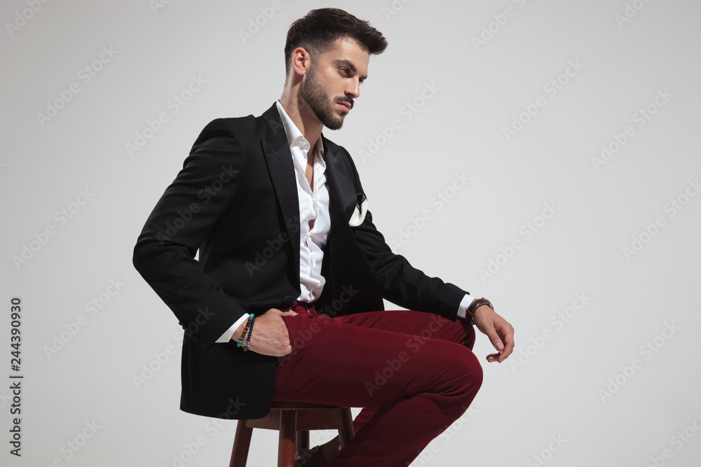 side view of seated smart casual man looking down side view of seated smart casual man looking down