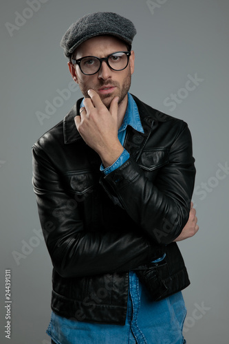 portrait of attractive man wearing leather jacket thinking