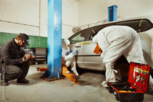 Crime scene investigation - inspection of suspected car in police garage photo