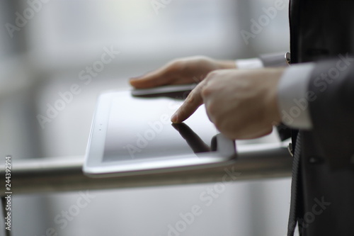 close up.businessman typing on a digital tablet