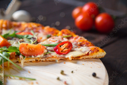 Yummi pizza with tomatoes ad chilli pepper photo