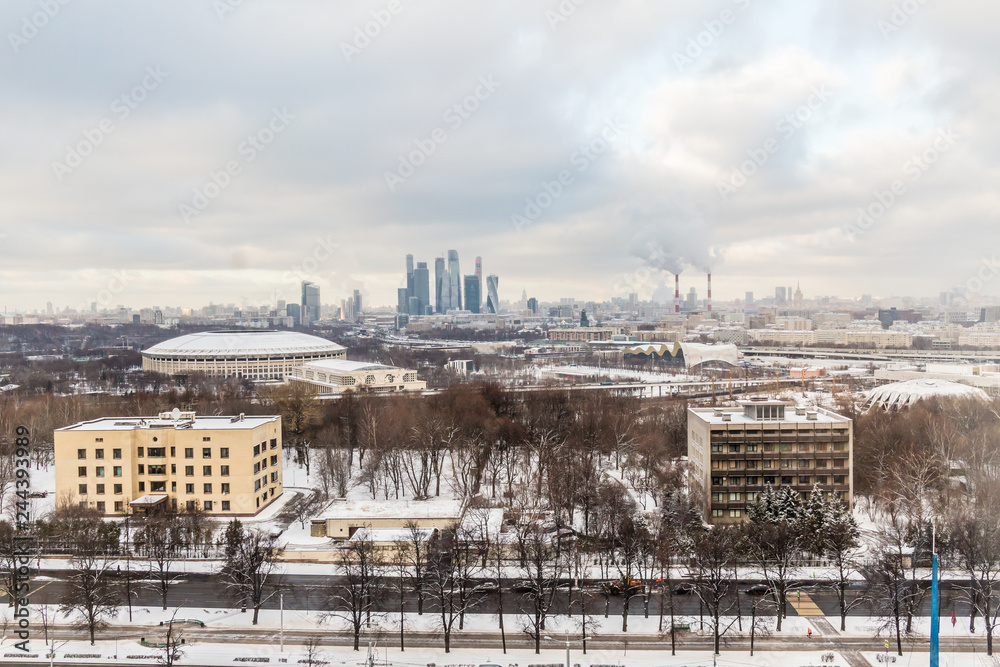 Urban landscape. Winter cloudy day. Smoke from the pipes of the combined heat and power plant. Moscow international business center 