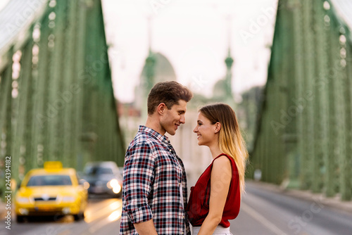 Photography Young loving couple hugging in the street.