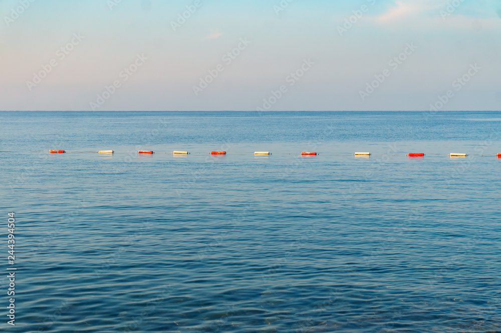 Row of red and white buoys in the sea
