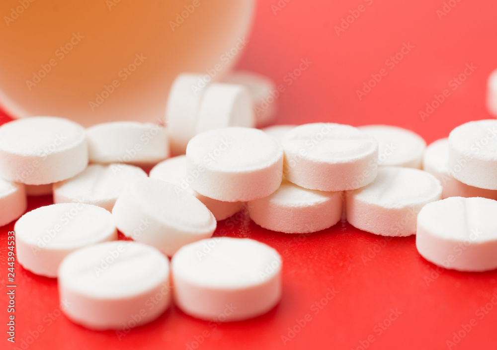 painkiller pills close up on red background painkiller pills close up on red background