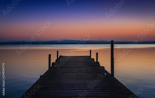 Pier at sunset on the lake © Emanuele Colombo