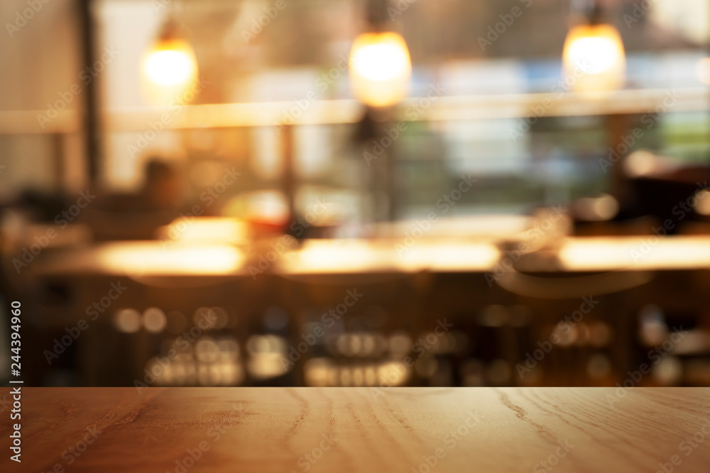 top of wood background with blur lamp light in cozy interior bar and restaurant background