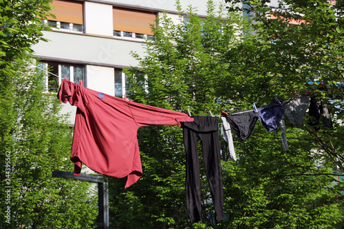 clothes hanging in a park outside a building photo