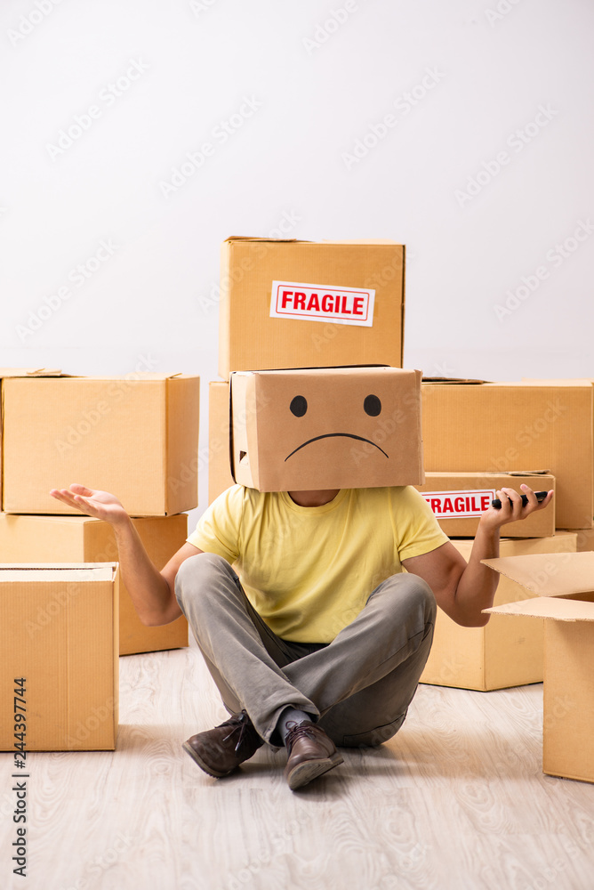 Unhappy man with box instead of his head Unhappy man with box instead of his head