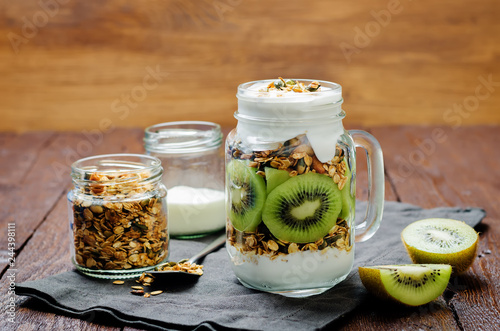 Greek yogurt granola kiwi breakfast in jar photo