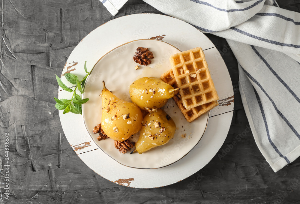 Plate with delicious poached pears in wine and waffles on plate Stock