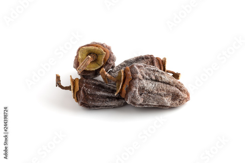 Dried persimmon on a white background. Fruits of dried persimmon close-up on a white background.