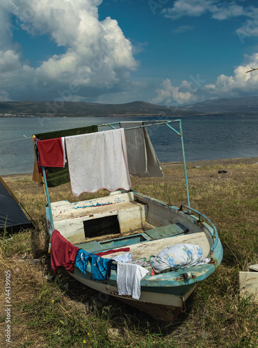 Wet clothes hanging on the boat. Background sea and sky.