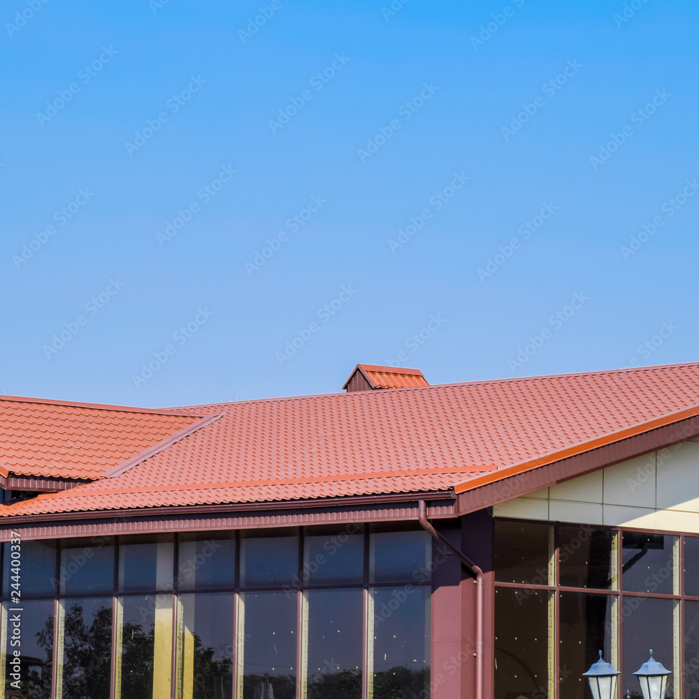 building with yellow walls and a red-brown roof. Modern material