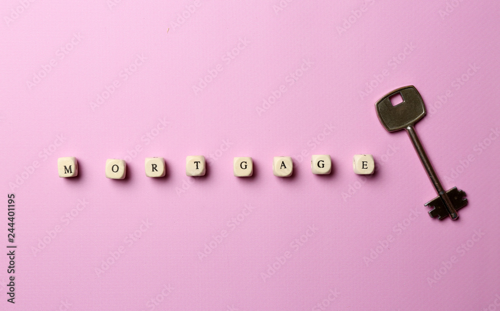 Word MORTGAGE composed of cubes and key on color background Word MORTGAGE composed of cubes and key on color background