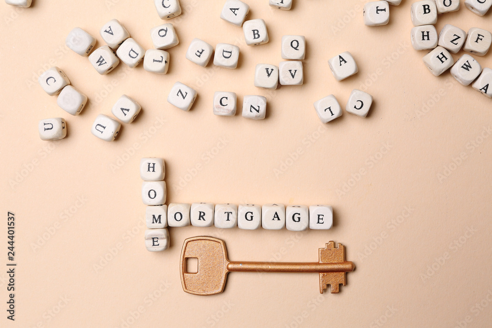 Words HOME and MORTGAGE composed of cubes and key on color background