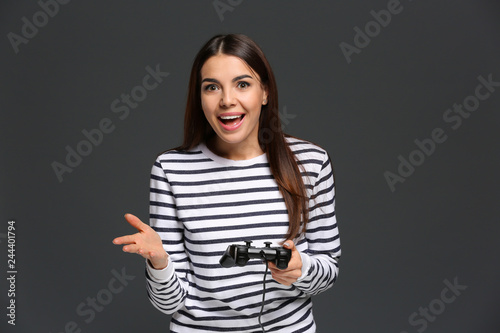 Emotional young woman playi...