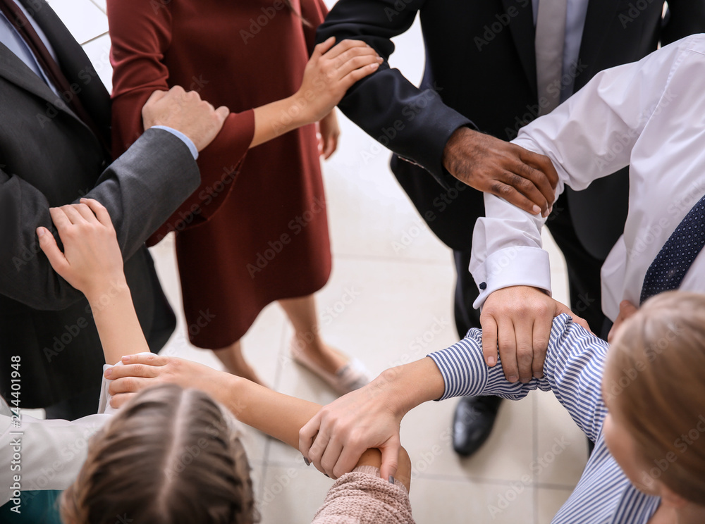 Group of people putting hands together at NLP training Group of people putting hands together at NLP training