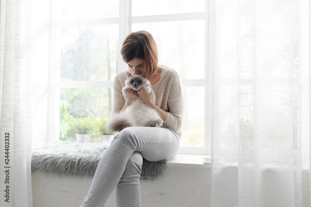 Woman hugging her cute cat at home Woman hugging her cute cat at home