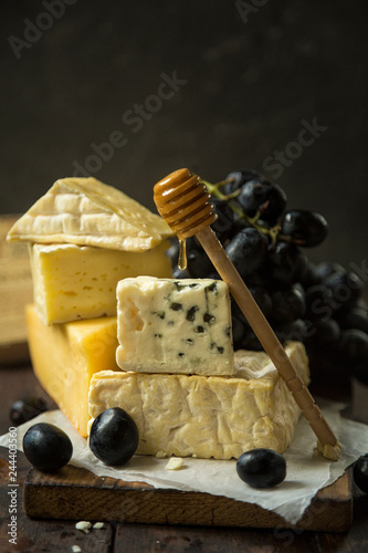 French cheese plate with grapes and honey photo
