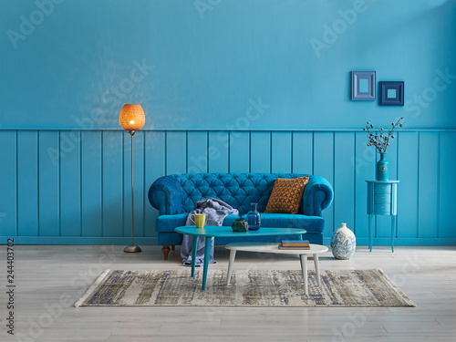 Blue living room, blue sofa and blue home decoration style with orange lamp.