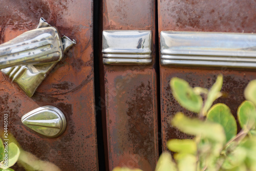 chrome door hadle, lock and trim of old rusted car photo