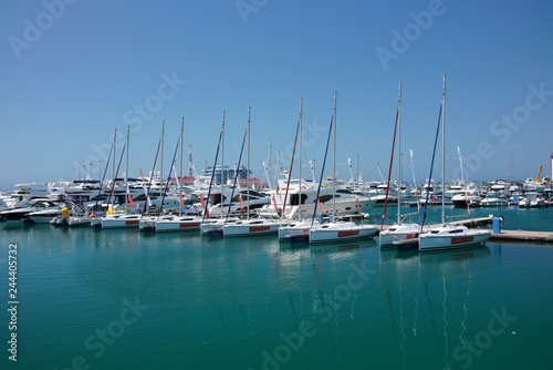 Sea pier with several rows of yachts and boats