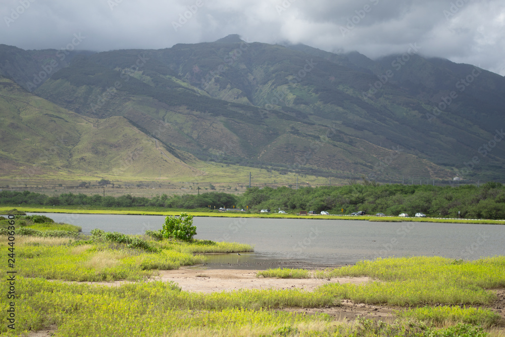 Stormy clouds on mountains over lake