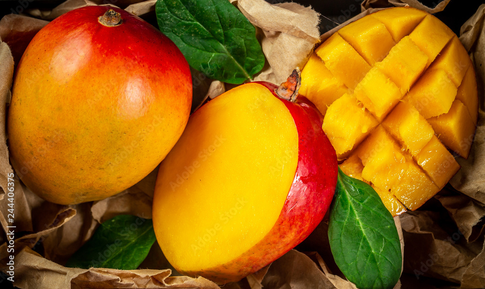 Famous Alphonso mango slices over wood background, Top view Famous Alphonso mango slices over wood background, Top view