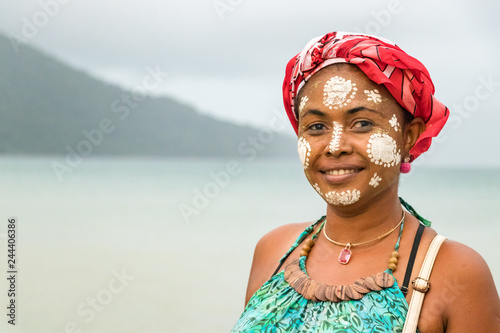 Portrait of a Malagasy woman with her face painted, Vezo-Sakalava tradition, Nosy Be, Madagascar. photo