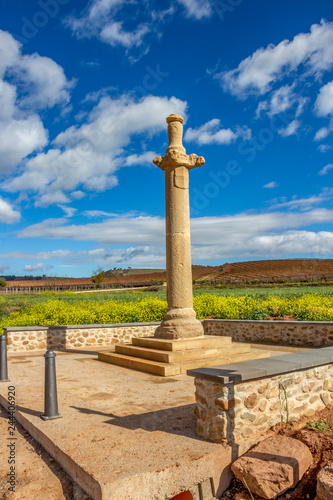 La Picota or Rollo de Azofra, an ancient roadside stone column, route Azofra-Ciruena on the Way of St. James, Camino de Santiago in La Rioja, Spain against a beautiful May sky photo