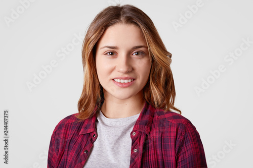 Portrait of happy European woman with dyed hair, being in good mood, rejoices day off, dressed in fashionable clothes, isolated over white background. Positive emotions and feelings concept. © sementsova321