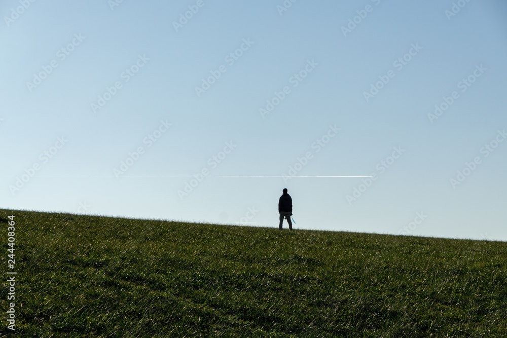 Fototapeta premium People walking on a meadow during sunset. Slovakia