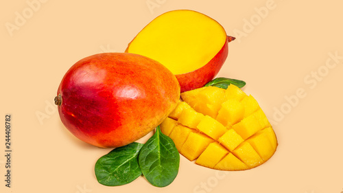 mango and mango slices Isolated on a beige background. Top view. Copy space. vertical image