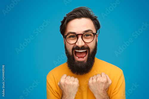 Bearded hipster celebrating victory