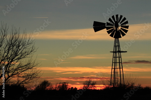 Windmill at Sunset with clouds and Silhouette.