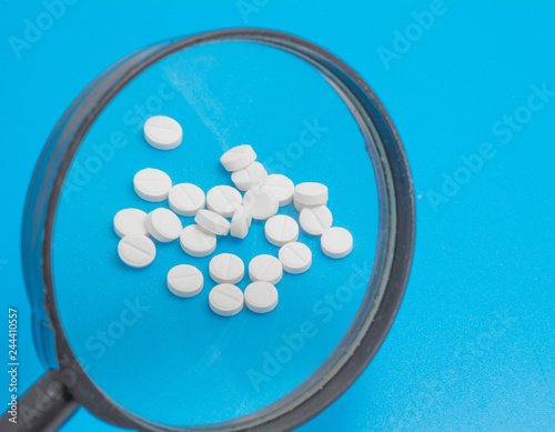 healthcare concept, white pills isolated on a blue background