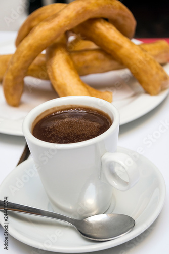 Churros with chocolate served in a cup
