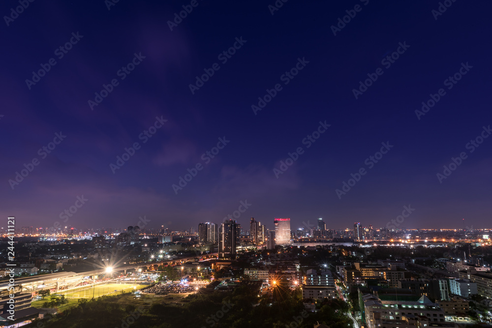 Beautiful aerial view of the city with football field in the night