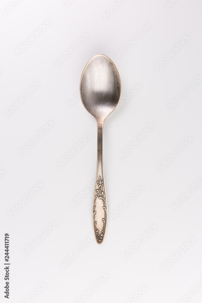 Spoon with ornate handle on white background - Image Spoon with ornate handle on white background - Image