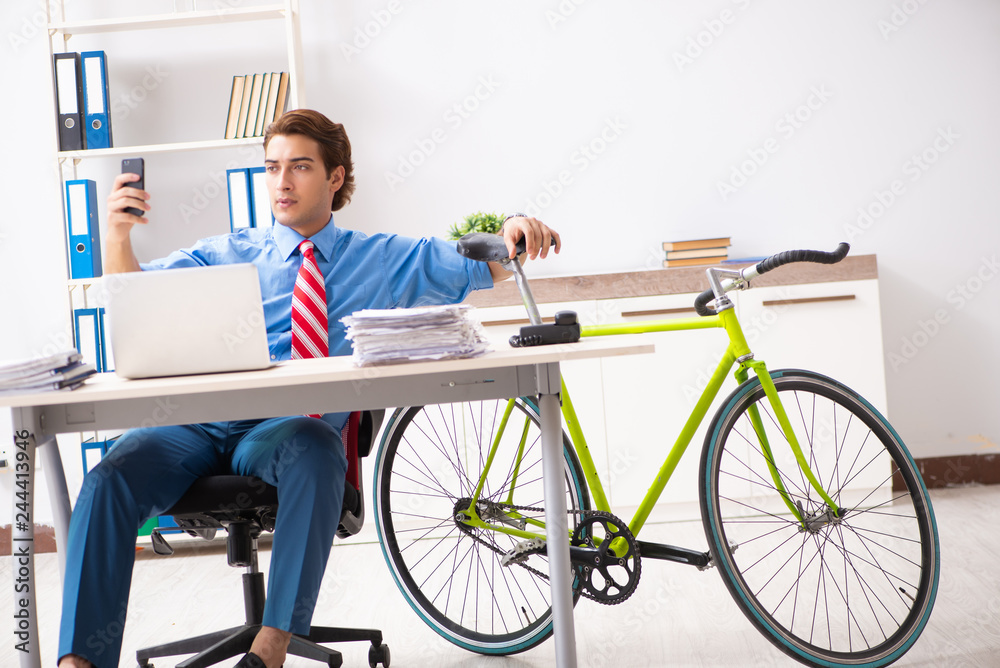 Young businessman using bike to commute to the office Young businessman using bike to commute to the office