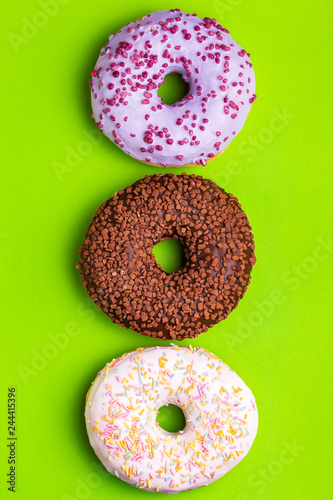 Three tastes of donuts: berry, chocolate and vanilla
