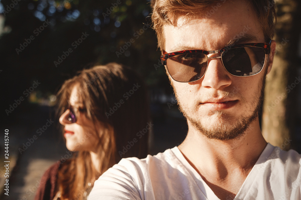 Stylish hipster couple making selfie and embracing in sunlight. Happy family couple in love making self portrait and posing in evening summer city. Vacation and travel together Stylish hipster couple making selfie and embracing in sunlight. Happy family couple in love making self portrait and posing in evening summer city. Vacation and travel together